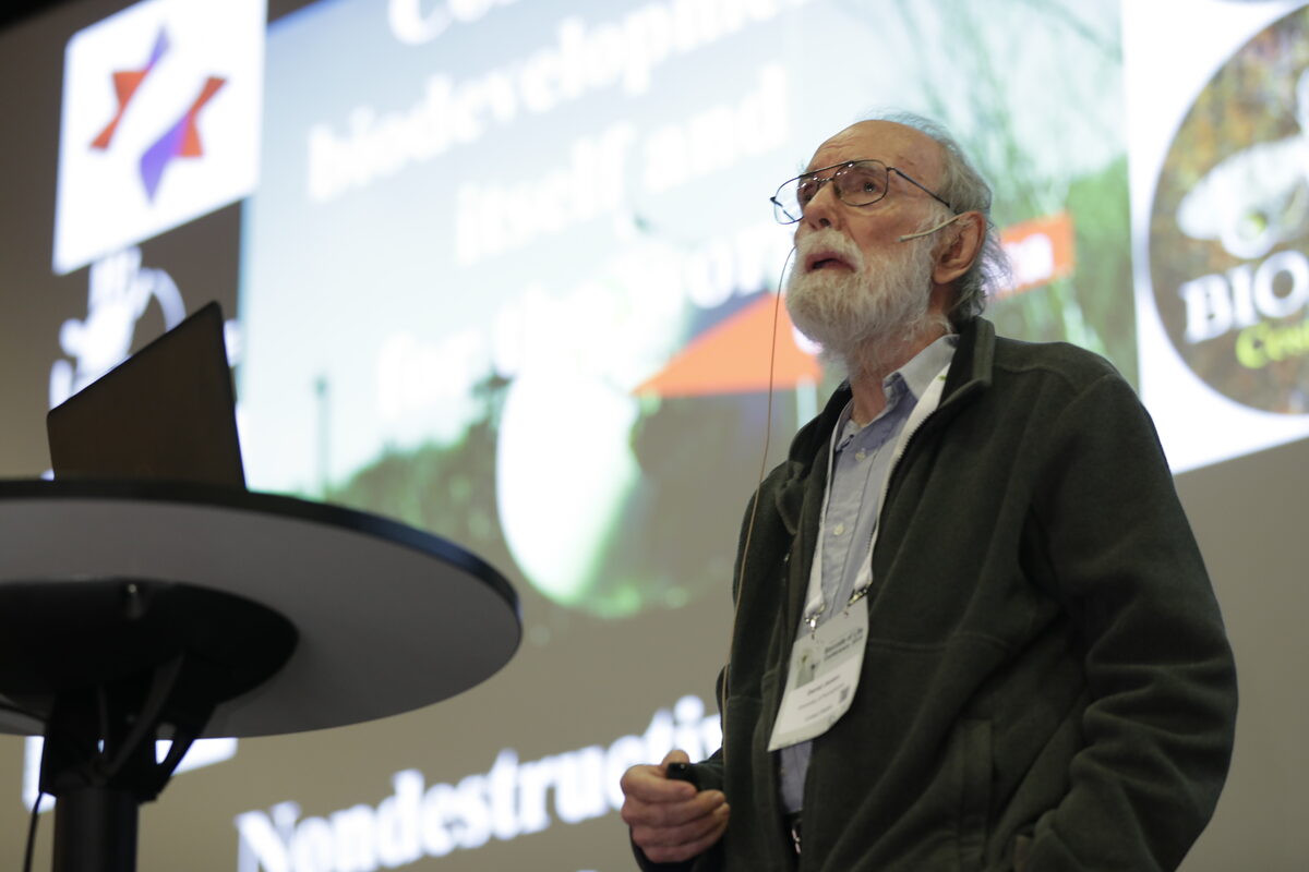 Daniel Janzen speaking at a conference