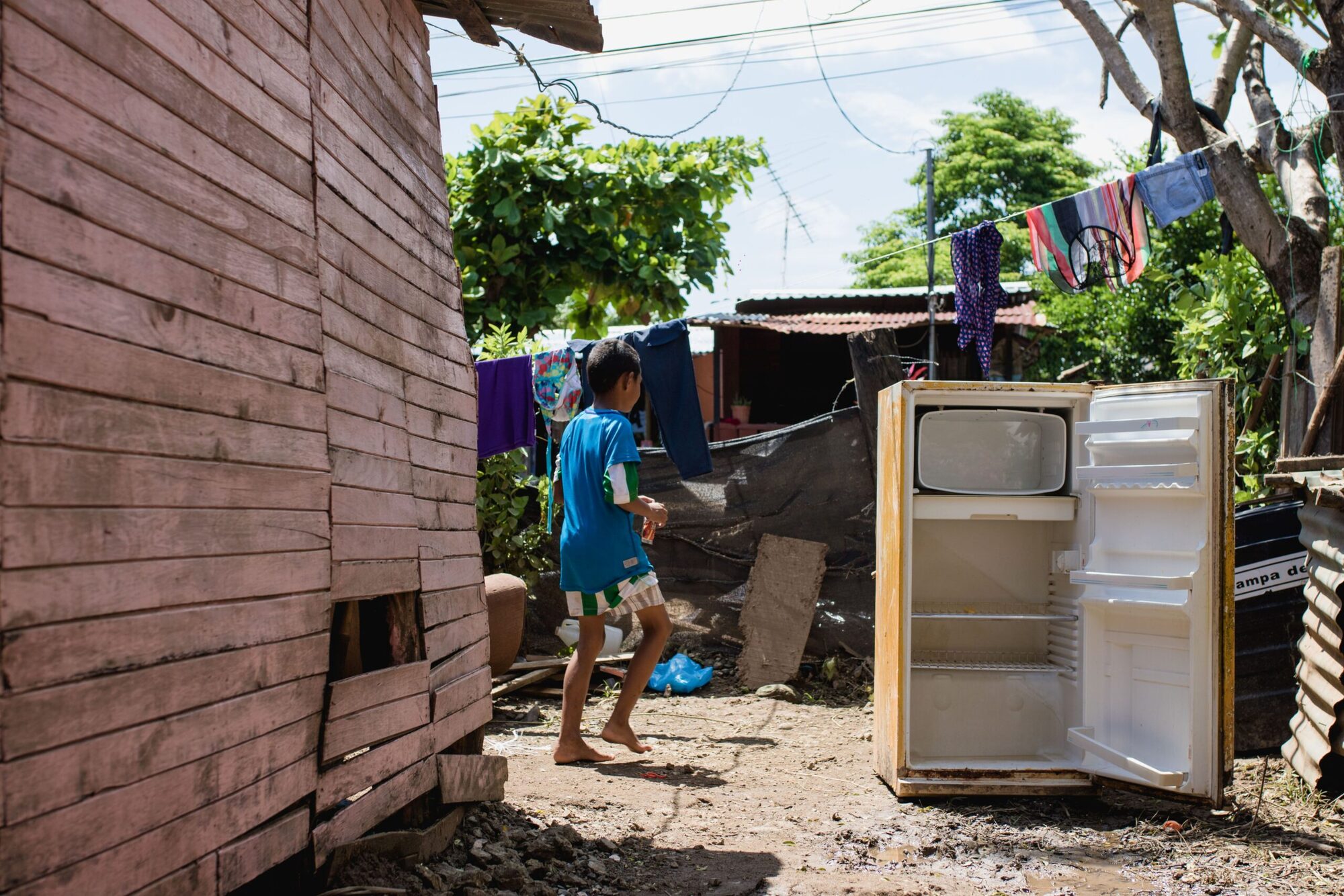 Informal settlement in Guanacaste showing modest wooden housing where tourism workers live