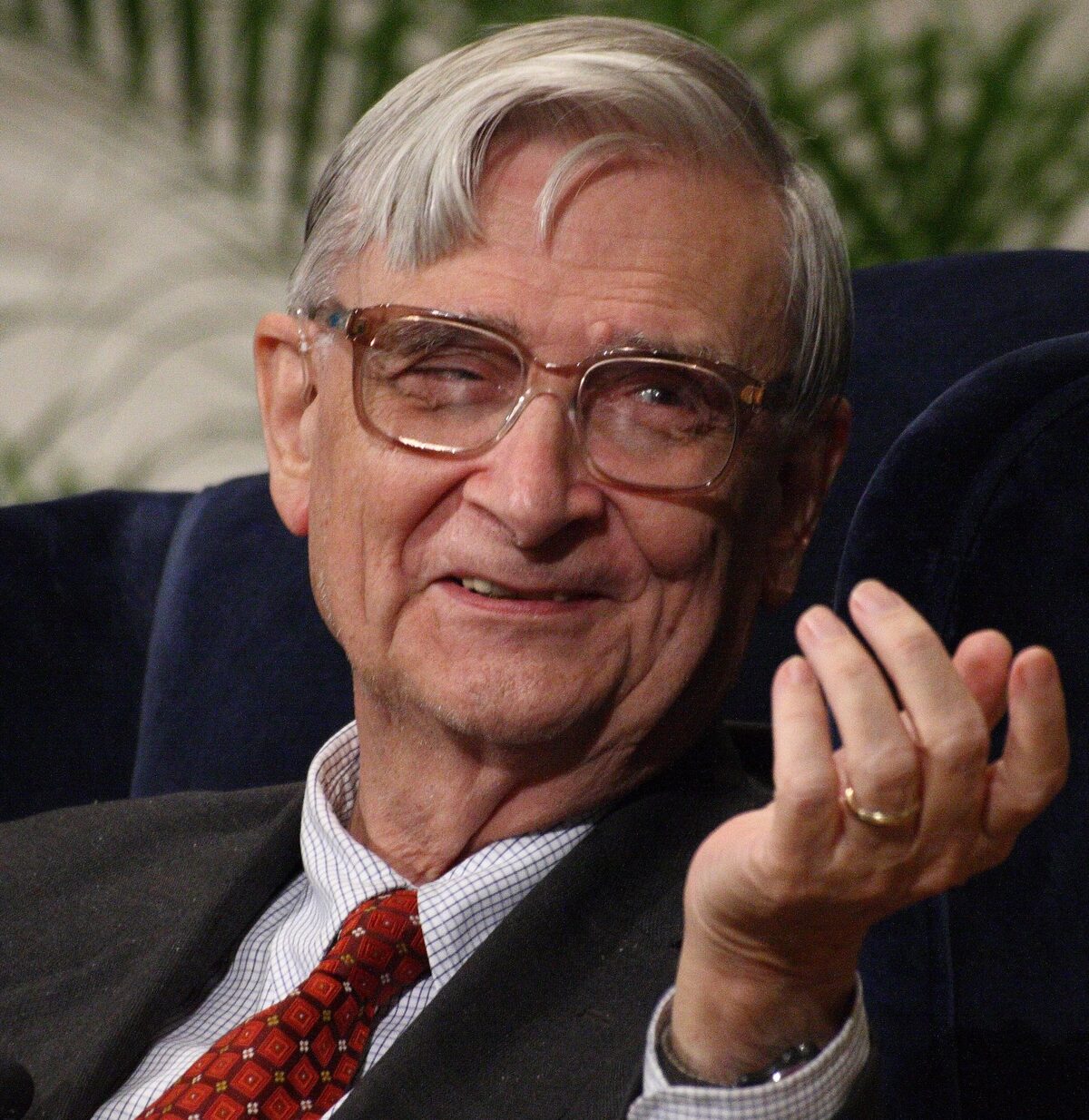 E.O. Wilson in 2007, sitting in a navy armchair, gesturing while speaking