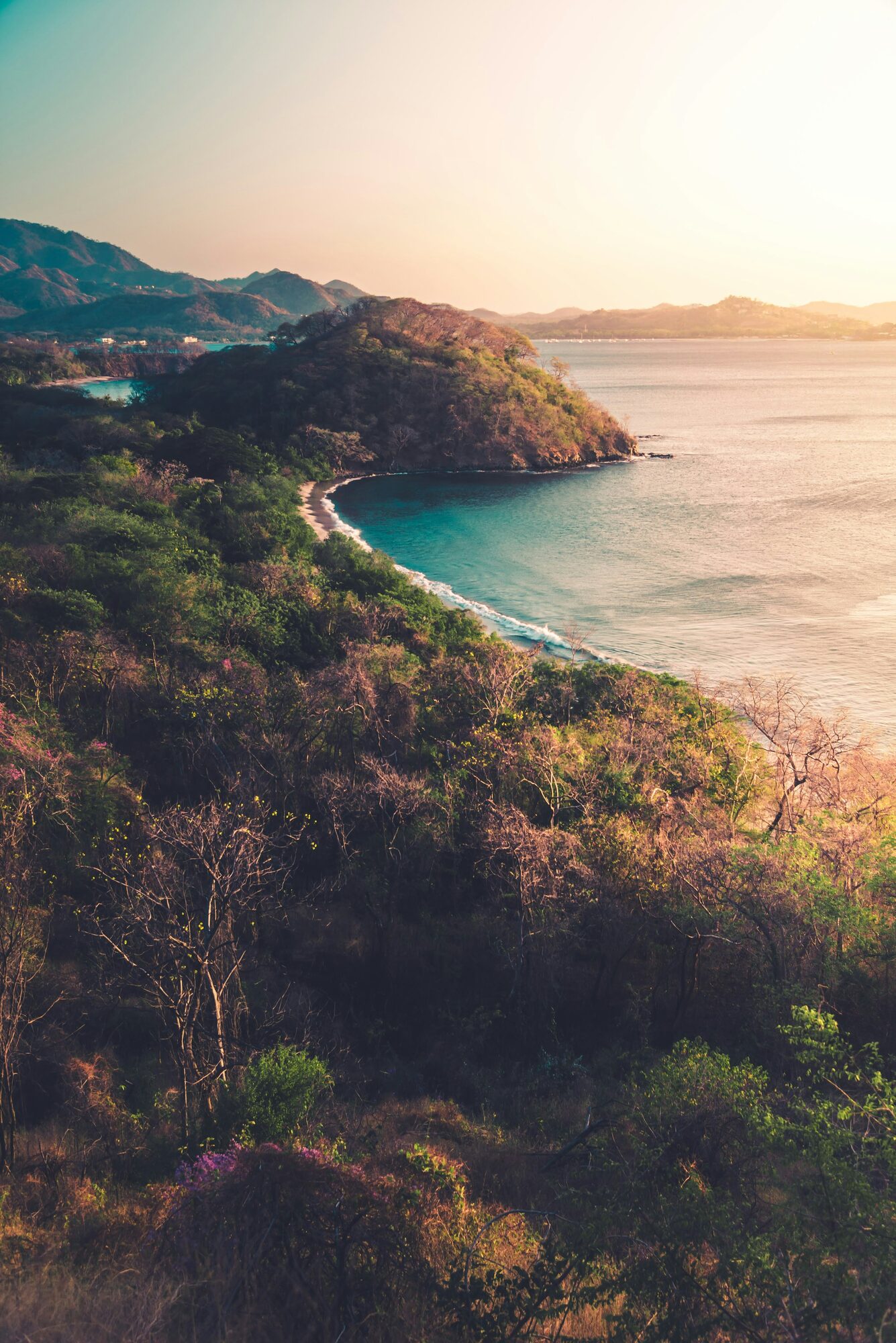 Costa Rican hillside landscape showing brown mountain slopes with green vegetation near the Pacific coast
