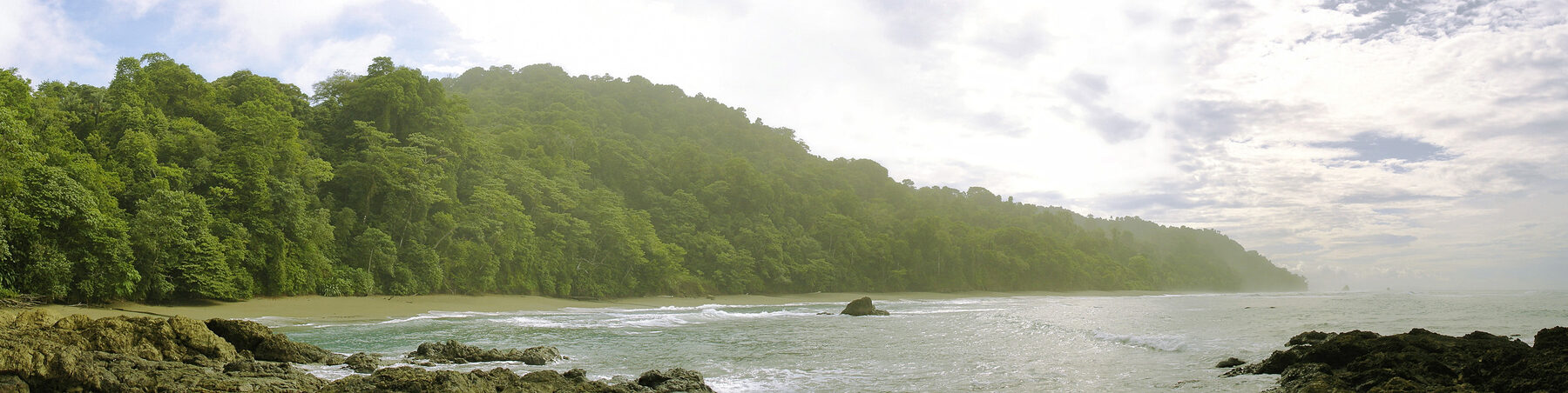 Rainforest-covered ridges dropping to the Pacific shore at Corcovado National Park, Osa Peninsula
