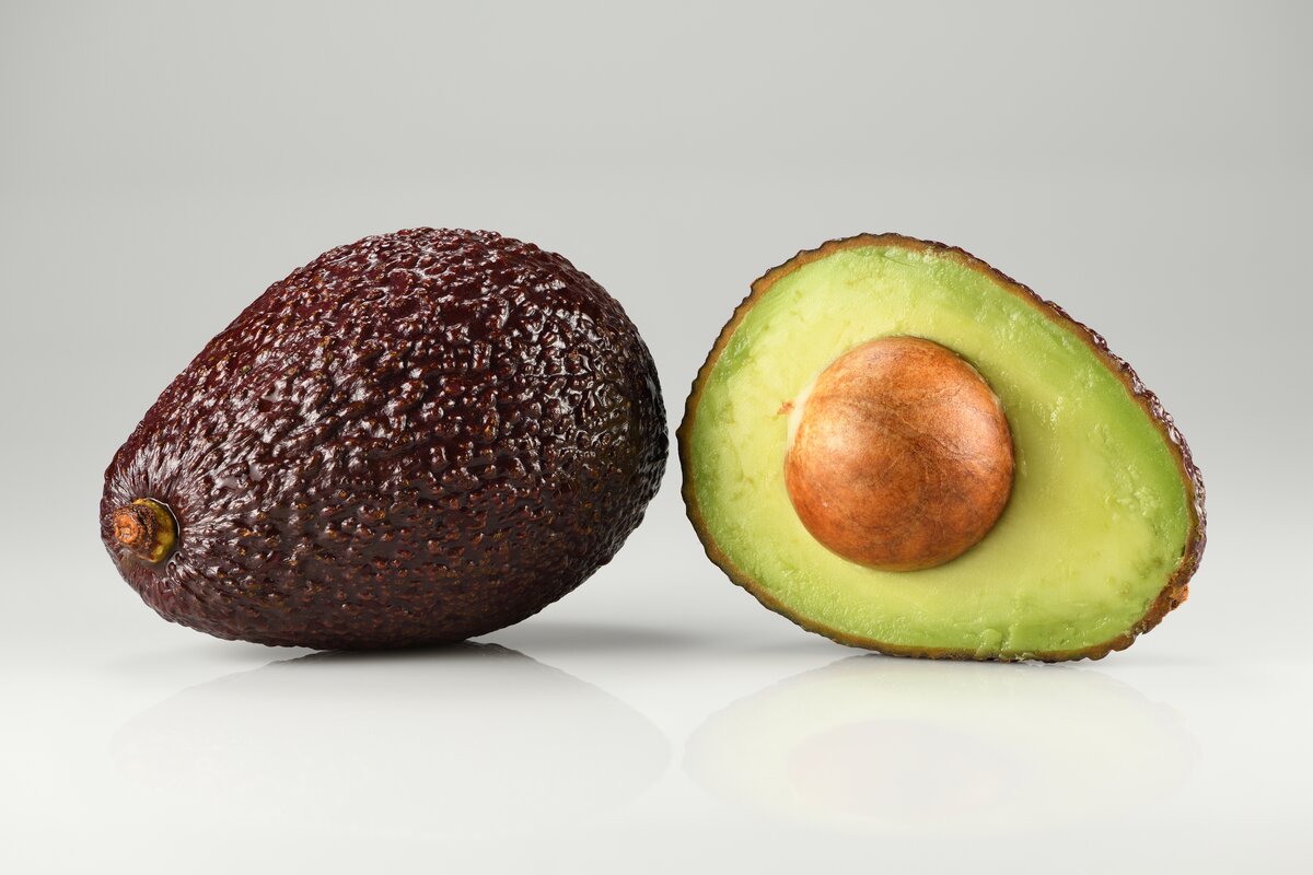 Hass avocado fruit showing cross-section with seed and flesh